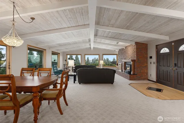 a living room with furniture a chandelier and a rug