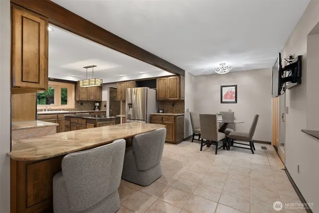 a dining room with furniture and a large window