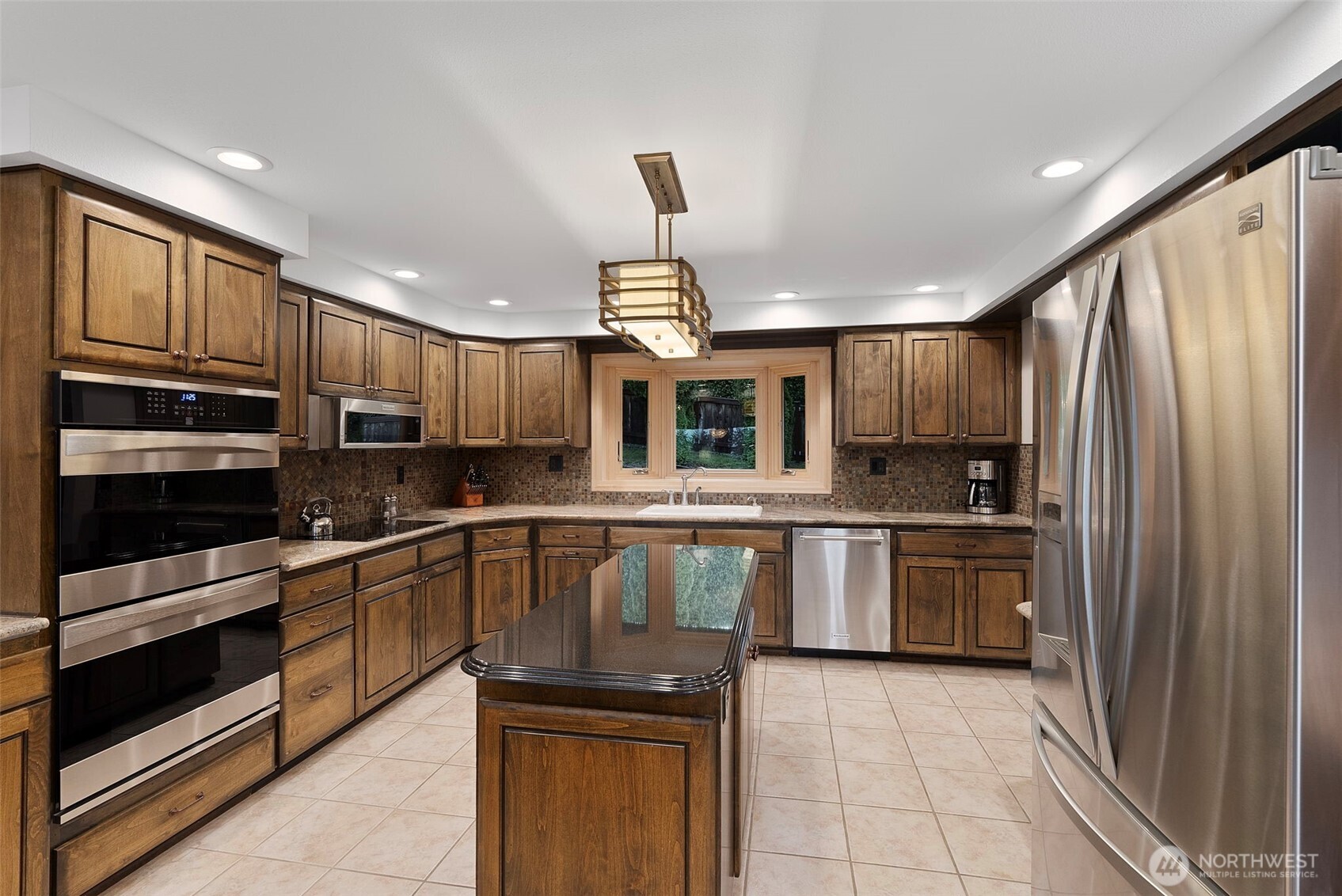 3321 Cooks Hill Road Centralia, WA 98531 - Photo 9 of 37 a kitchen with kitchen island granite countertop wooden cabinets and a stainless steel appliances