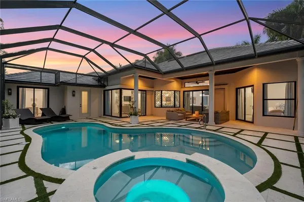 a swimming pool with outdoor seating yard and furniture