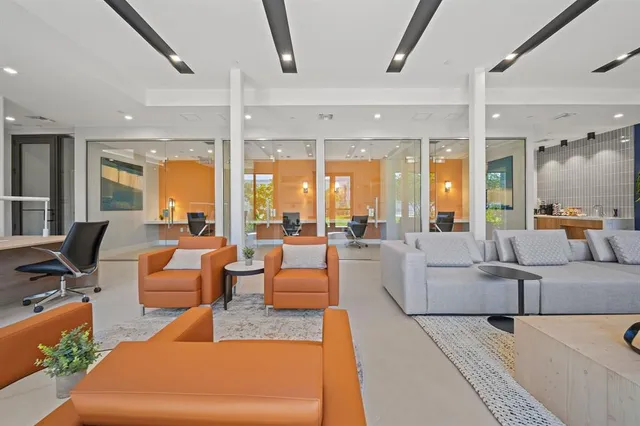 a living room with furniture and large windows