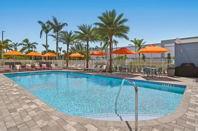 a view of swimming pool with outdoor seating and yard in the back
