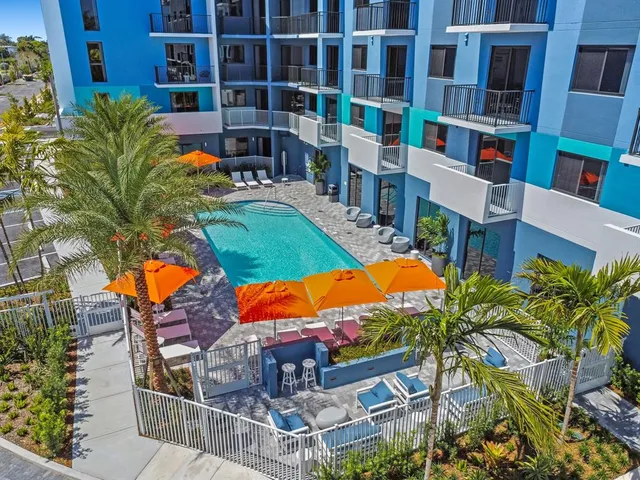 an aerial view of residential houses with yard and swimming pool