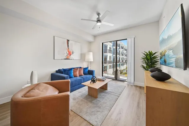 a living room with furniture and a large window