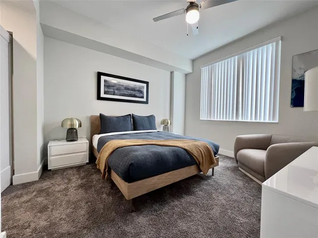 a spacious bedroom with a bed and window