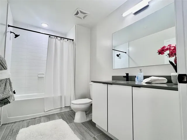 a bathroom with a sink toilet and shower