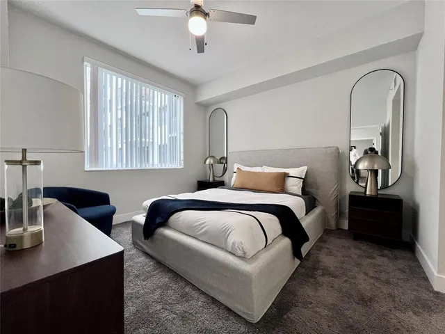 a bedroom with bed and a table