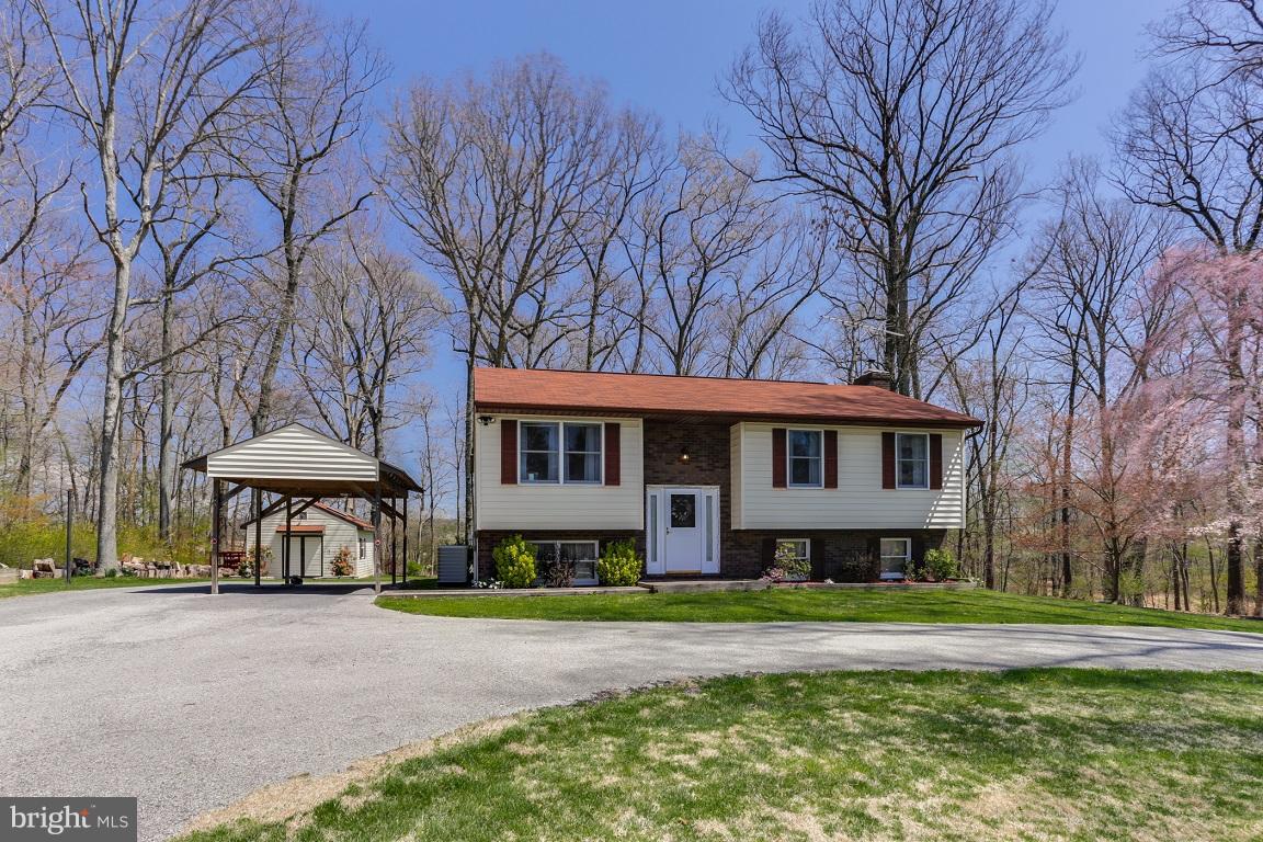 921 Emory Church Road Upperco, MD 21155 - Photo 2 of 30 a front view of a house with a yard and trees