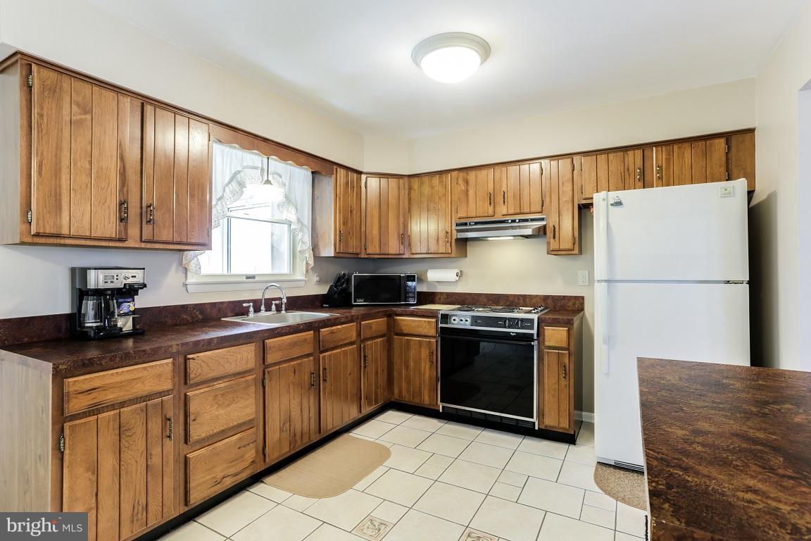 921 Emory Church Road Upperco, MD 21155 - Photo 11 of 30 a kitchen with stainless steel appliances granite countertop a refrigerator sink and stove