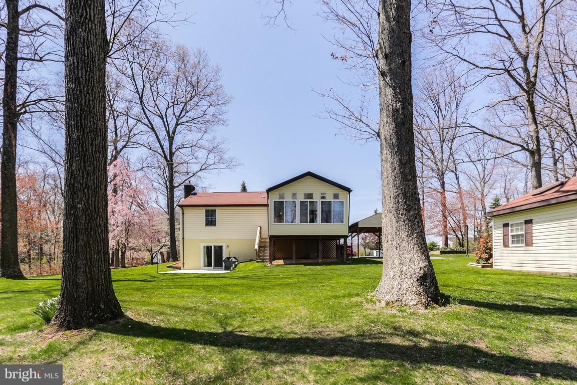 921 Emory Church Road Upperco, MD 21155 - Photo 26 of 30 a front view of a house with a yard table and chairs