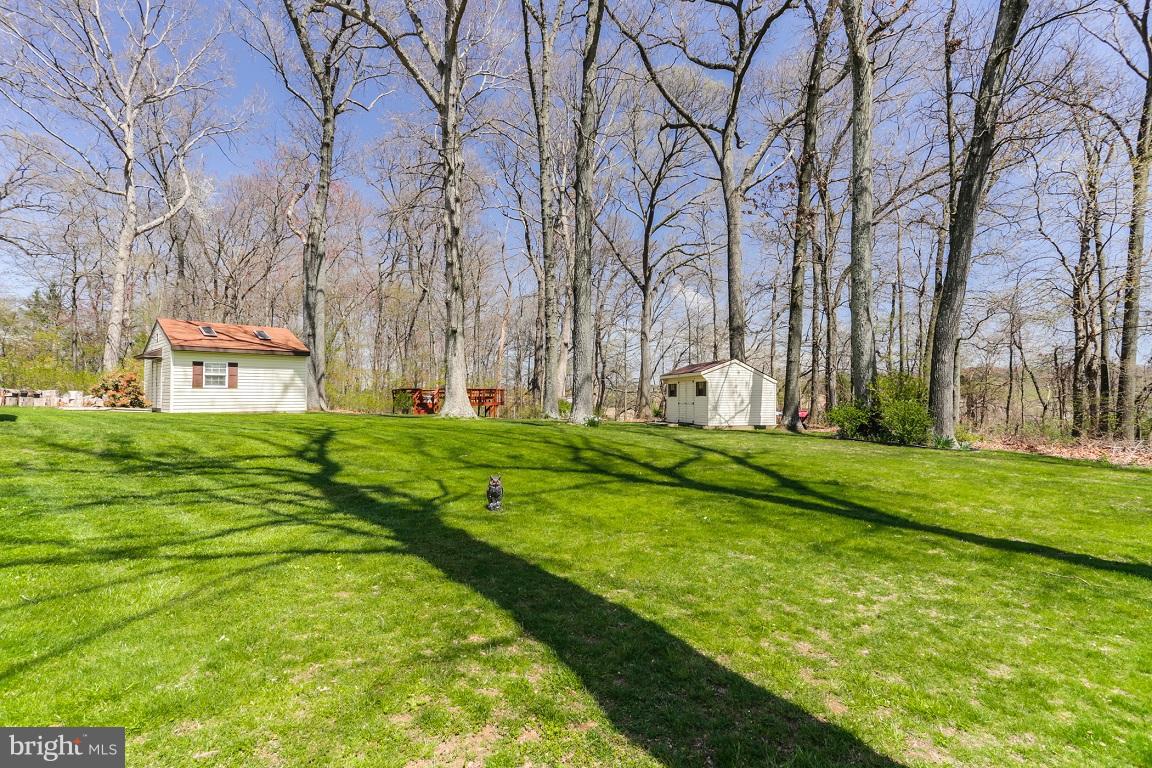 921 Emory Church Road Upperco, MD 21155 - Photo 29 of 30 a backyard of apartments with large trees