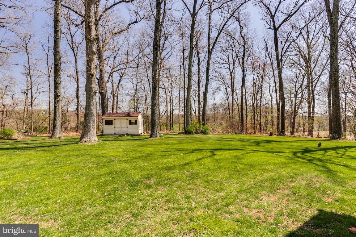 921 Emory Church Road Upperco, MD 21155 - Photo 30 of 30 a backyard of apartments with large trees