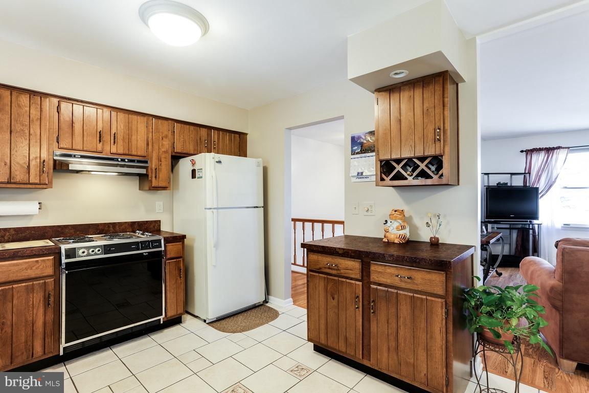 921 Emory Church Road Upperco, MD 21155 - Photo 10 of 30 a kitchen with stainless steel appliances granite countertop a refrigerator sink and stove