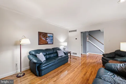 a bedroom with a bed couch and a lamp on table