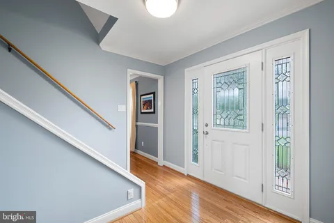 a view of an entryway with wooden floor