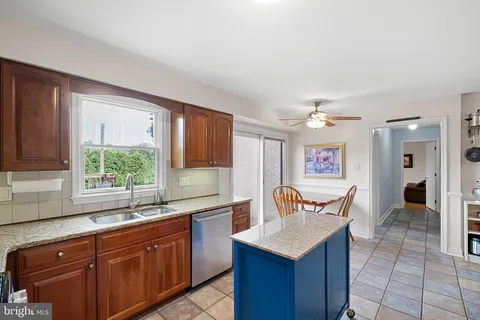 a kitchen with a sink a counter top space and a window