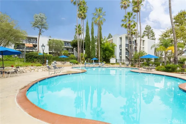 a swimming pool with outdoor seating and yard