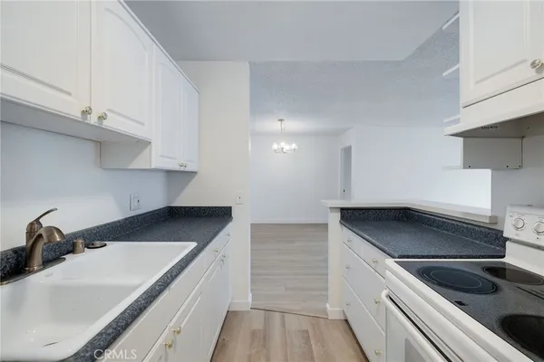 a kitchen that has a sink and a stove