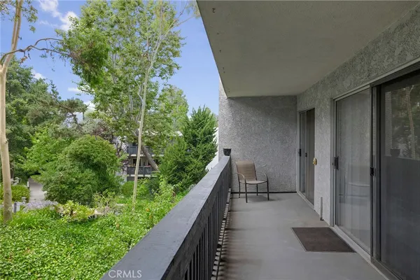 a view of balcony and yard