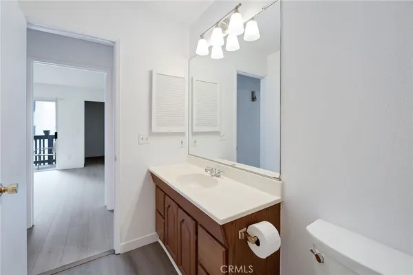 a bathroom with a toilet a sink and a mirror