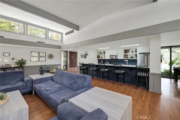 a living room with furniture and kitchen view