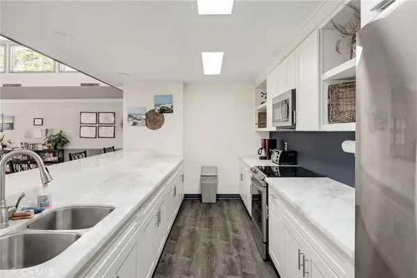 a large white kitchen with a sink