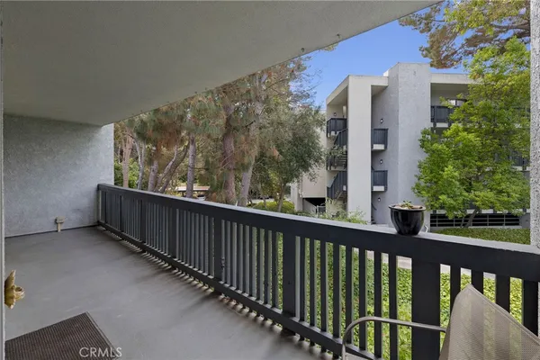 a view of a balcony with wooden fence and floor