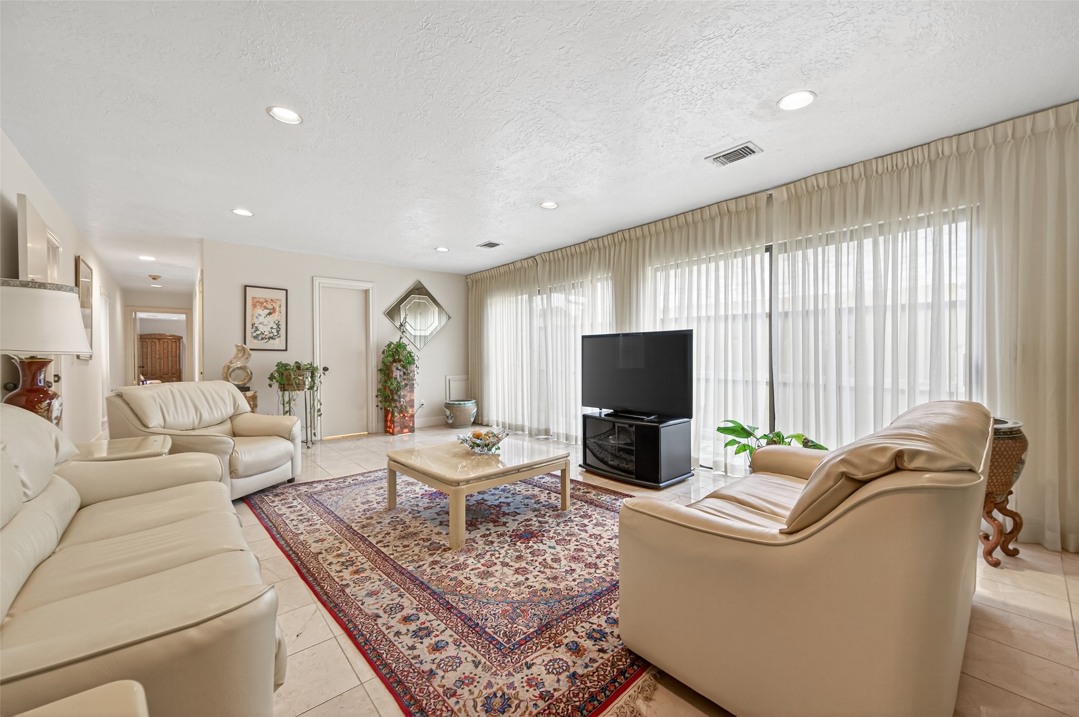 8103 Lake Edge Court Houston, TX 77071 - Photo 19 of 48 Light-filled living area with expansive windows and media layout