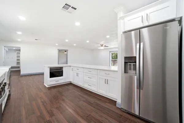 a kitchen with stainless steel appliances a refrigerator sink and microwave