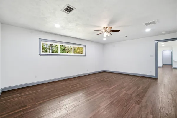 wooden floor in an empty room with a window