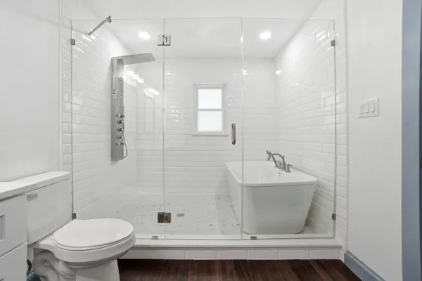 a bathroom with a sink a toilet and shower