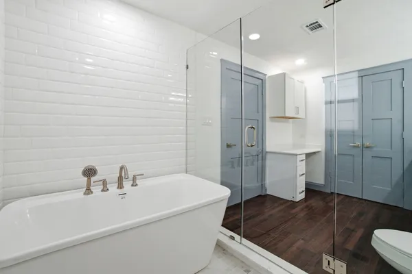 a bathroom with a sink a toilet and shower