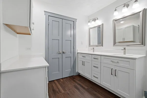 a spacious bathroom with a granite countertop sink and a mirror