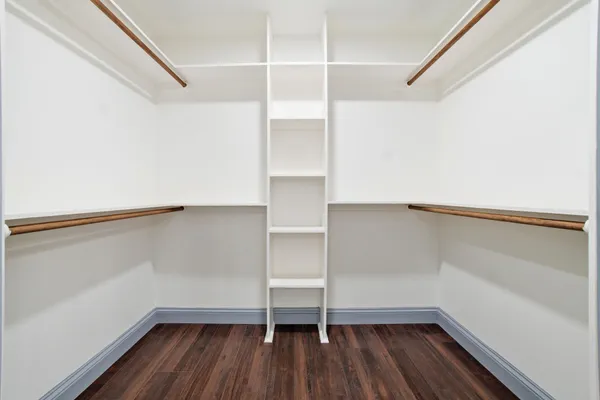 a view of walk in closet with empty racks