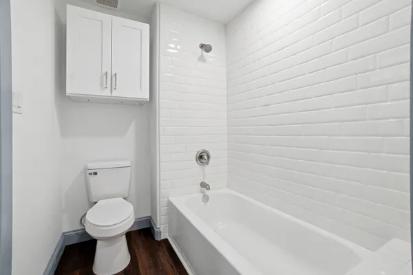 a bathroom with a toilet a sink and bathtub