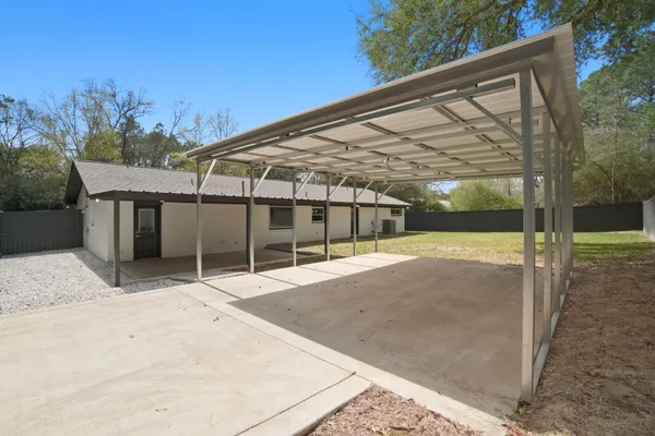 a backyard of a house with table and chairs