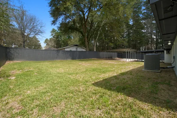 a swimming pool with trees in the background