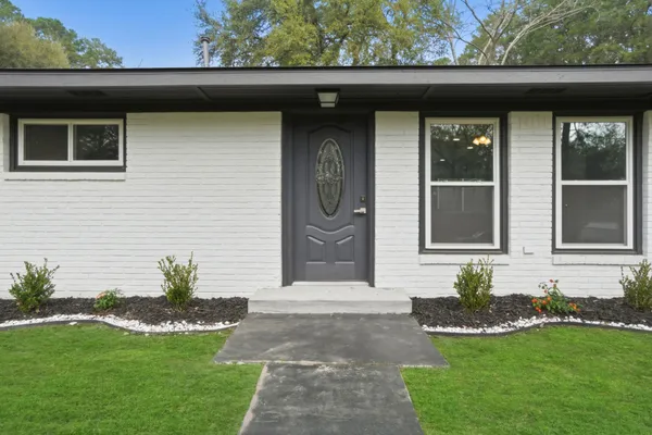 a front view of a house with a garden