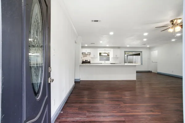 a view of kitchen and hall with wooden floor