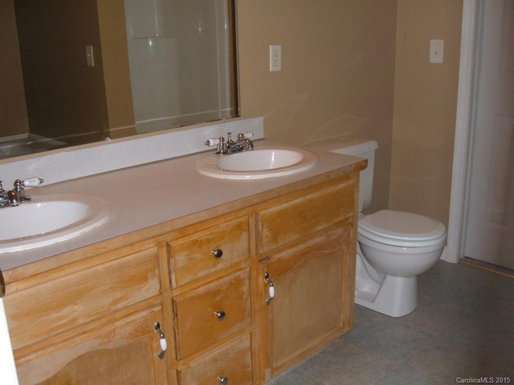 3527 East North Corner Road Lancaster, SC 29720 - Photo 16 of 23 a bathroom with a sink a toilet and mirror