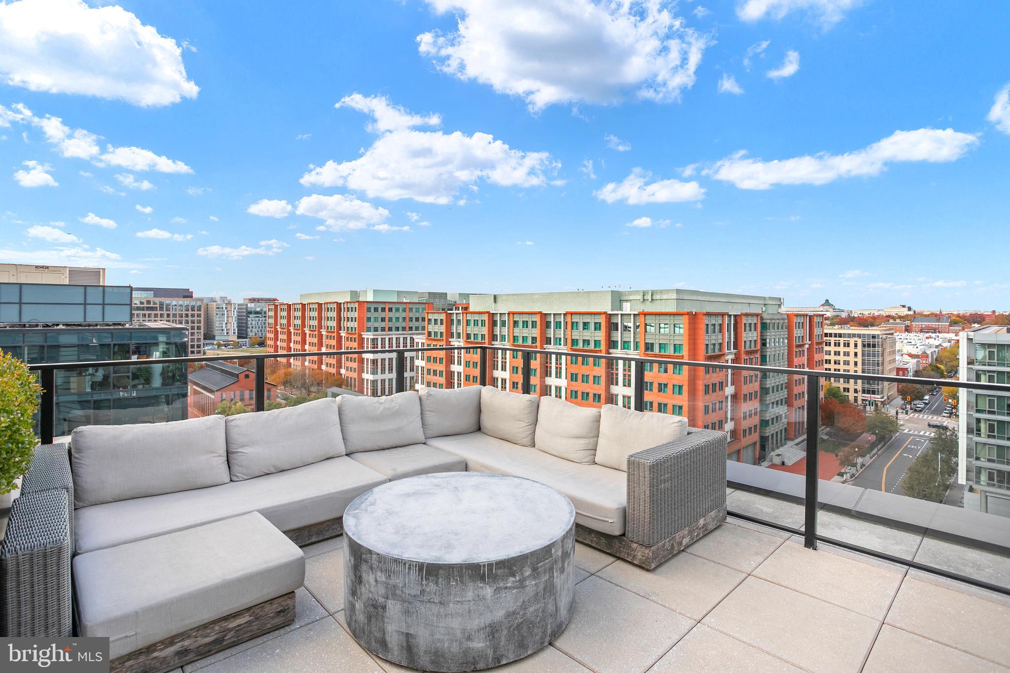 1300 4th Street Southeast, Unit 901 Washington, DC 20003 - Photo 16 of 27 a balcony with furniture and city view
