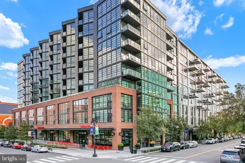 a front view of a building with a garden