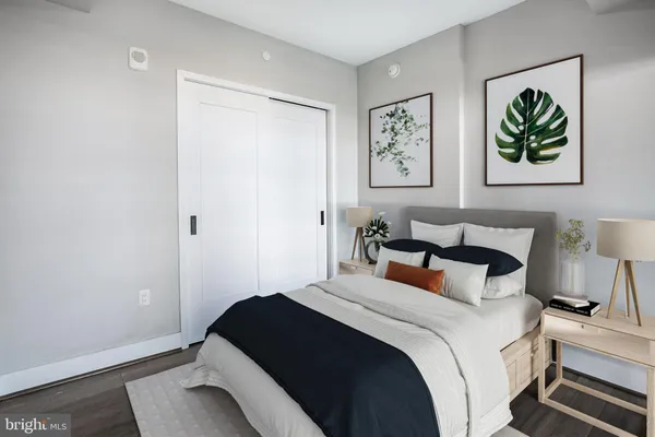 a bedroom with bed and painting on the wall