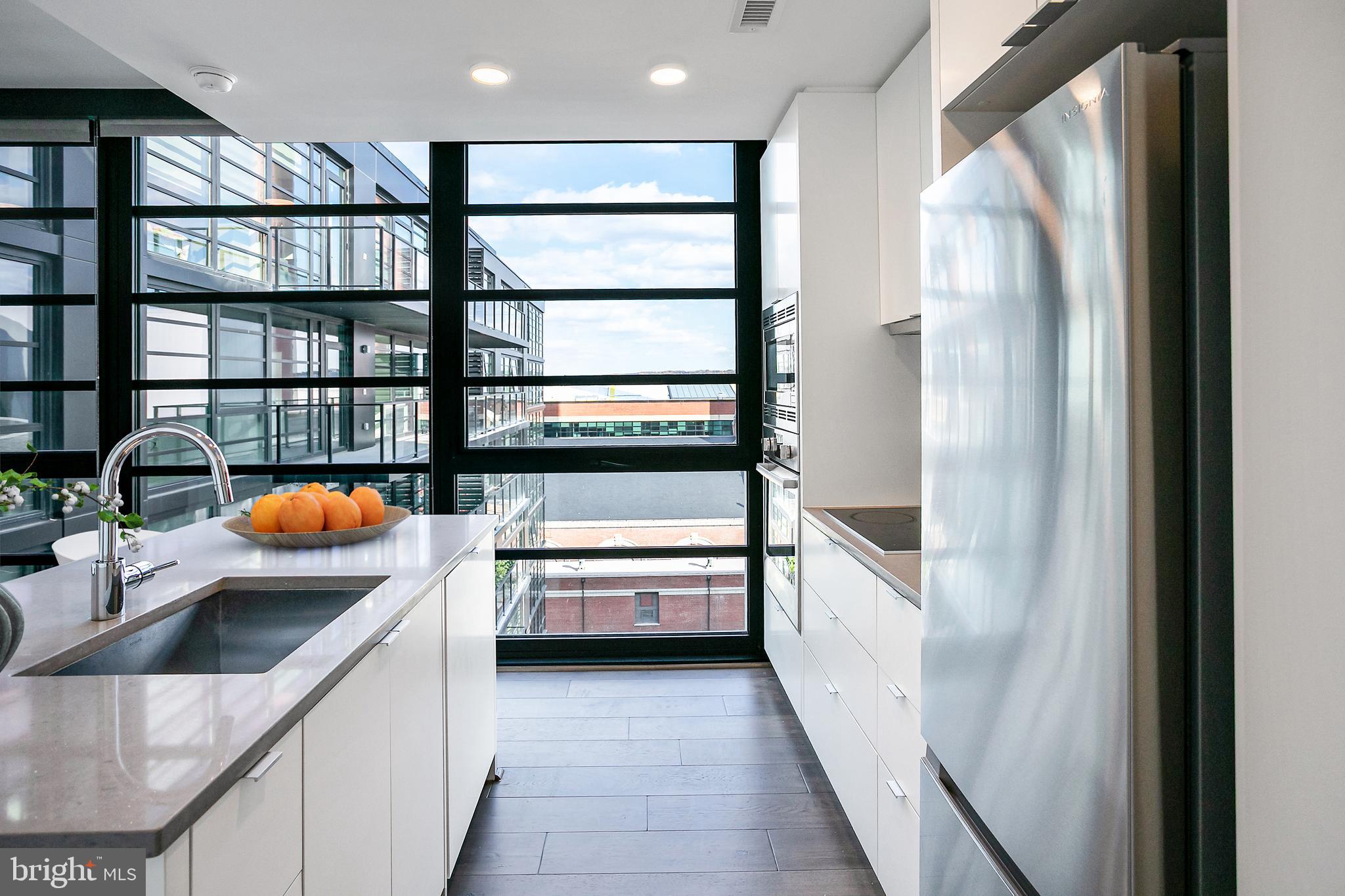 1300 4th Street Southeast, Unit 901 Washington, DC 20003 - Photo 8 of 27 a kitchen with stainless steel appliances a sink and a refrigerator