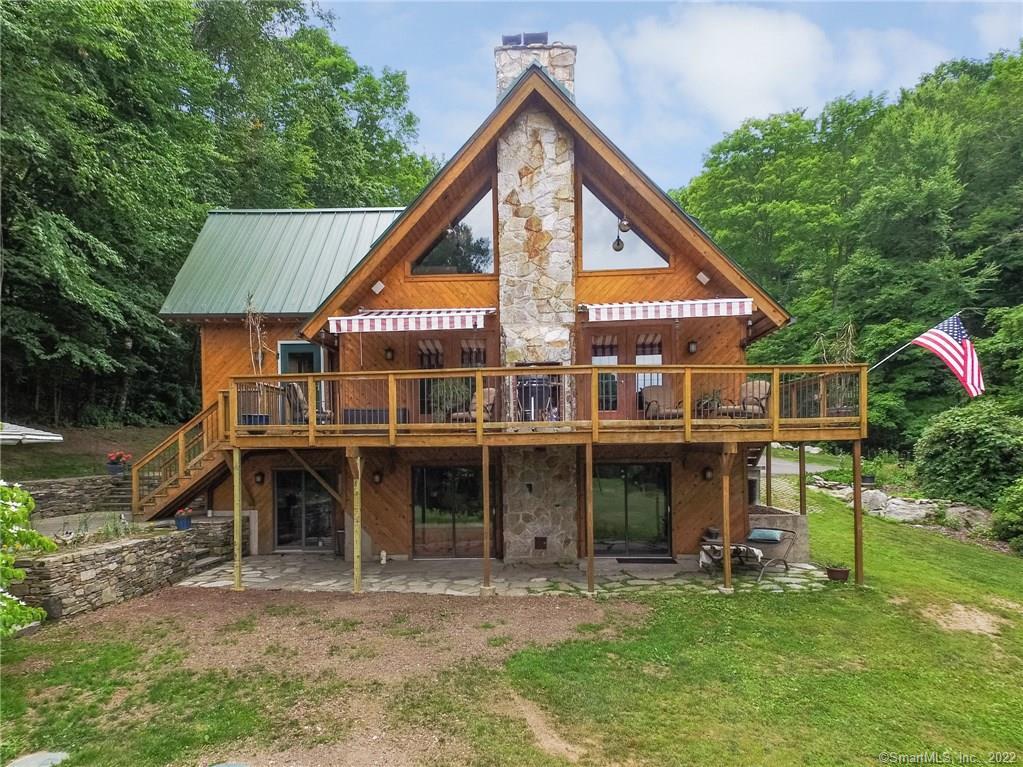 a view of a house with a yard patio and a slide