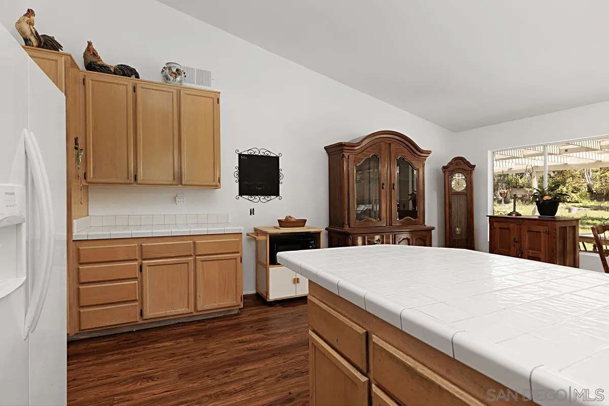 1505 Avenida Oceano Oceanside, CA 92056 - Photo 11 of 26 a large kitchen with kitchen island a sink stainless steel appliances and cabinets