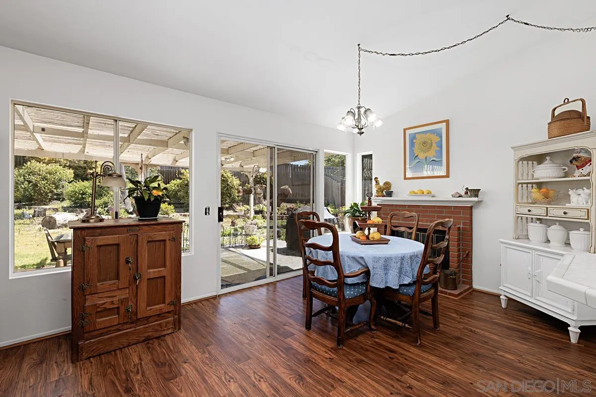 1505 Avenida Oceano Oceanside, CA 92056 - Photo 12 of 26 a dining room with furniture a window and wooden floor