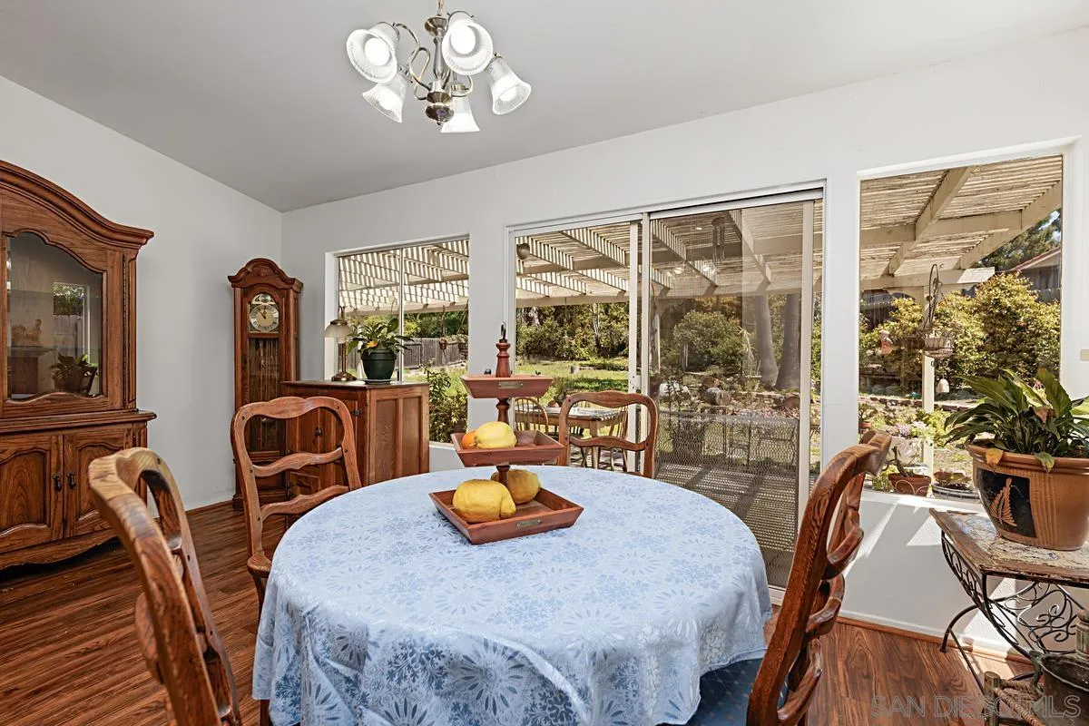 1505 Avenida Oceano Oceanside, CA 92056 - Photo 13 of 26 a view of a dining room with furniture a chandelier and large windows