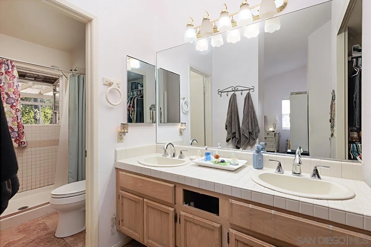 1505 Avenida Oceano Oceanside, CA 92056 - Photo 17 of 26 a bathroom with a sink a toilet and a mirror