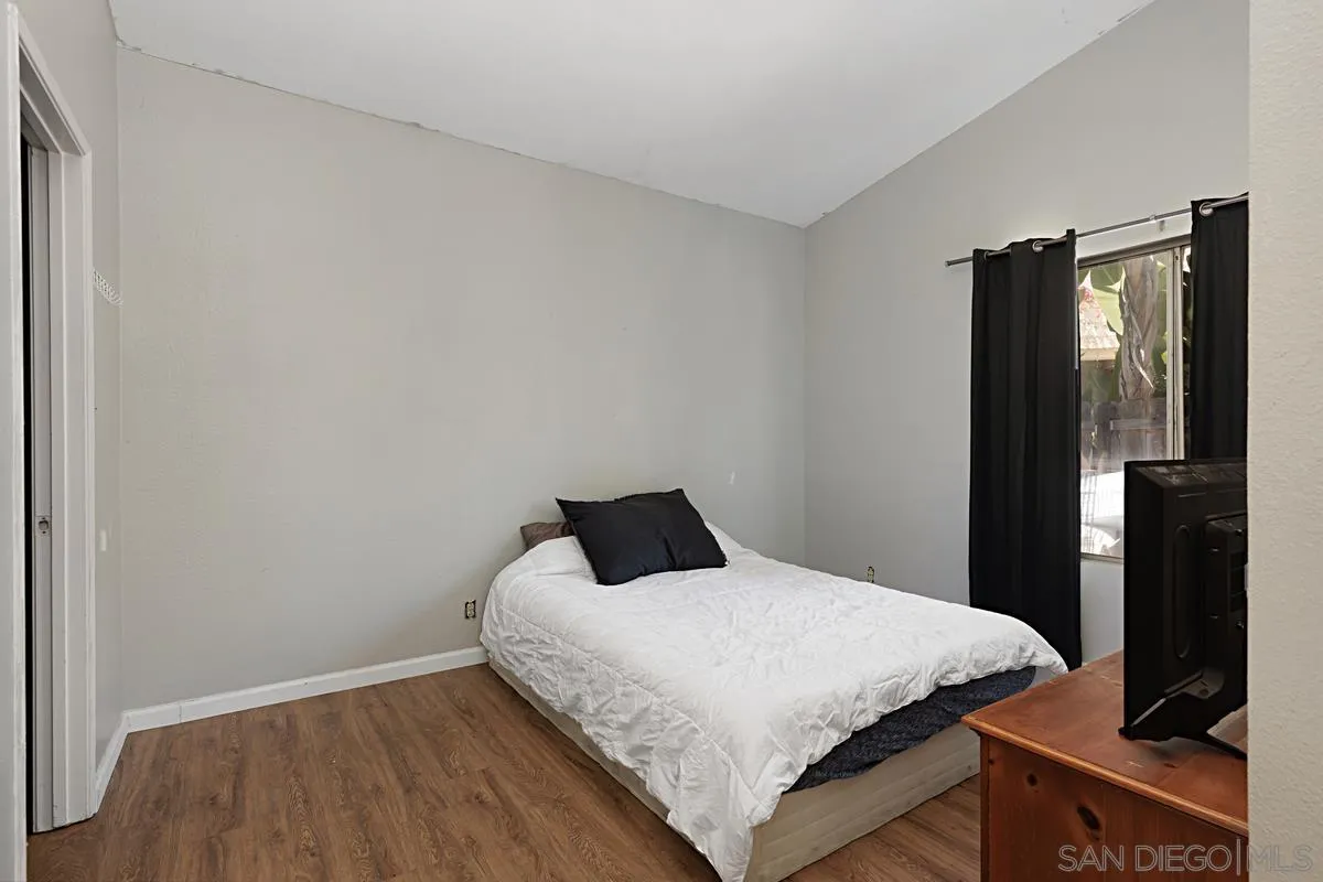 1505 Avenida Oceano Oceanside, CA 92056 - Photo 19 of 26 a bedroom with a bed and wooden floor